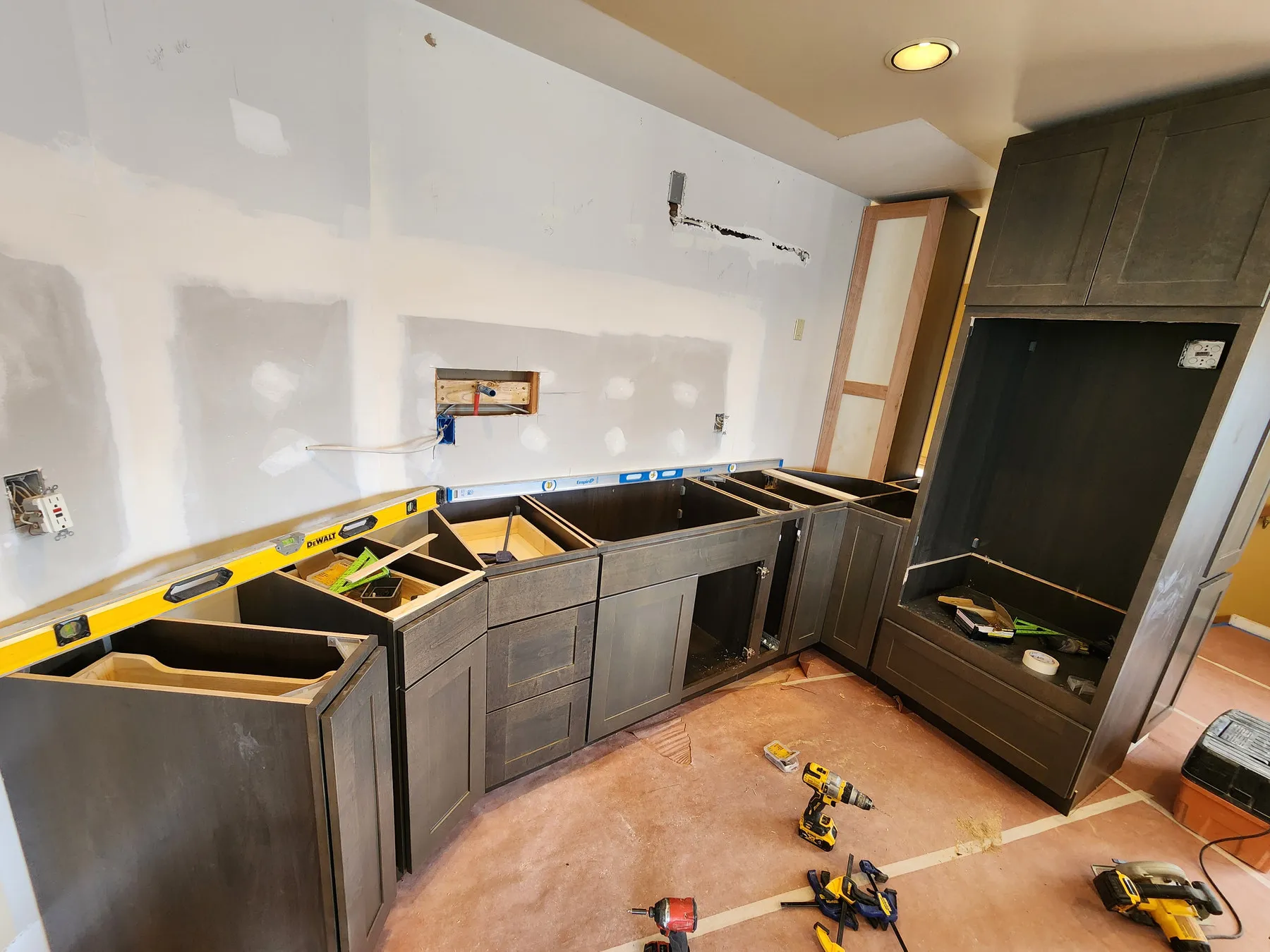 Dark shaker base cabinets set level and square before the countertop is templated