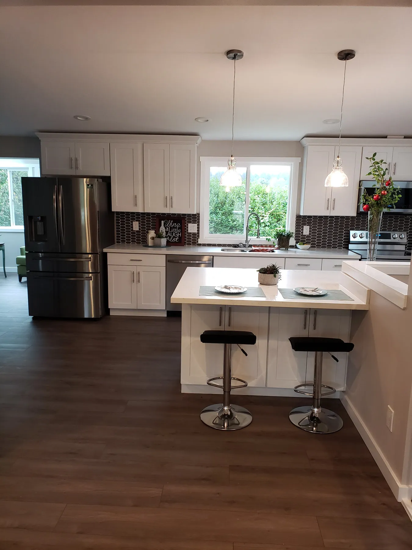 After — half-wall and bare subfloor to a white kitchen with an island — Ballard, Seattle