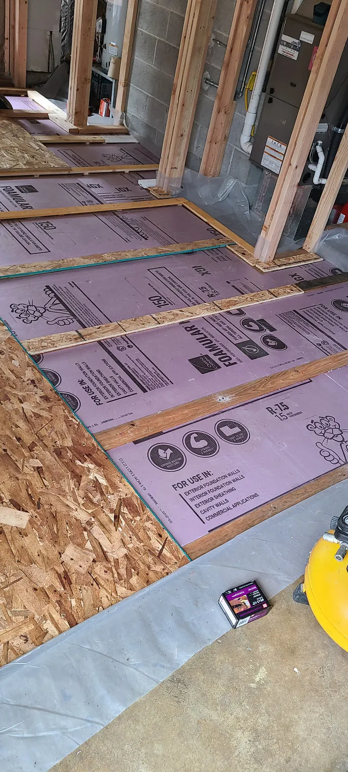 Insulation board laid over a bathroom subfloor, the deck exposed and checked before the new floor goes on