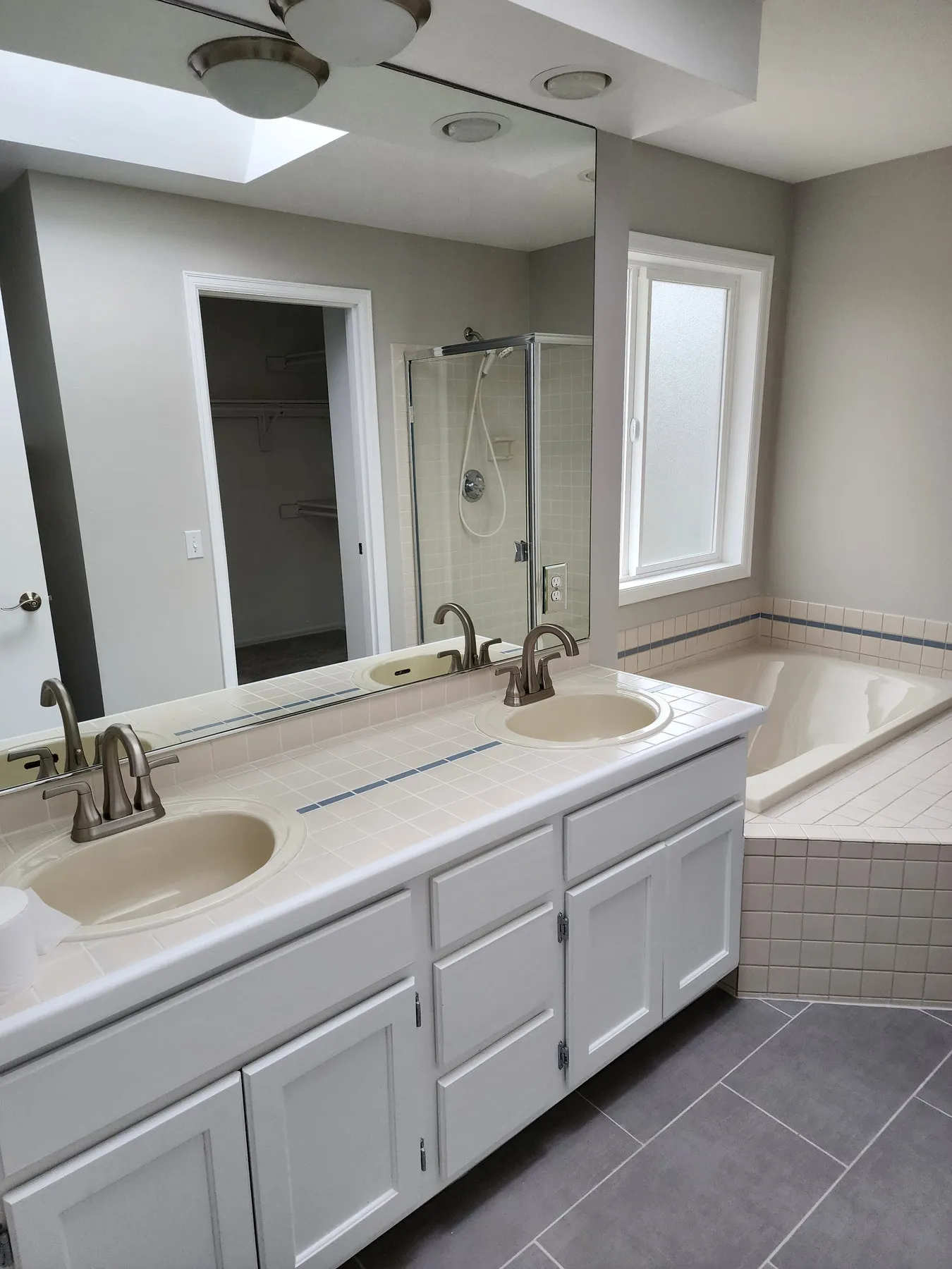 Before — laminate double vanity and corner tub to shaker and freestanding — Overlake, Redmond